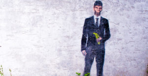 an image of some street art depicting a gorilla in a suit holding a banana