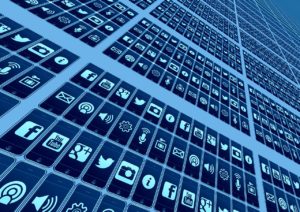 A wall of all of the different social media logos, such as twitter, facebook, and instagram, repeated over and over again.